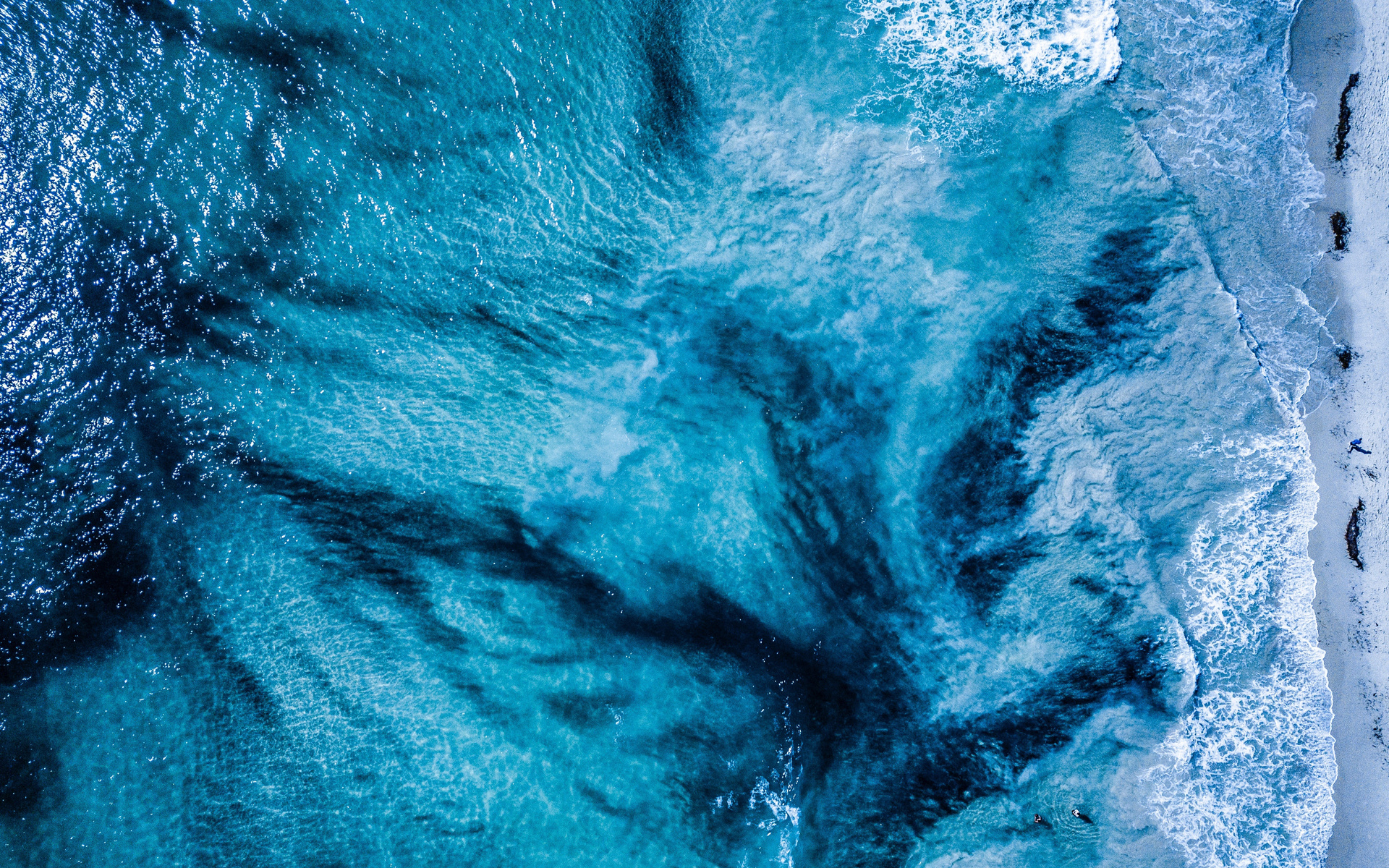 an aerial view of the ocean and waves